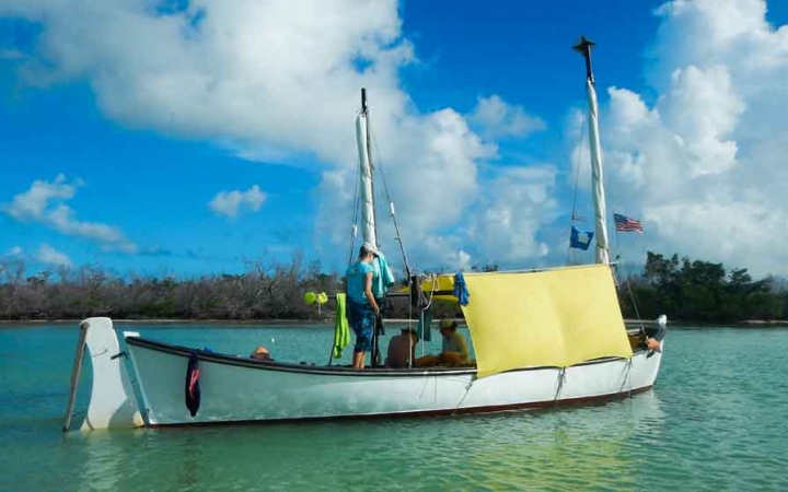 a sailboat floats in calm blue water on an outward bound expedition in florida